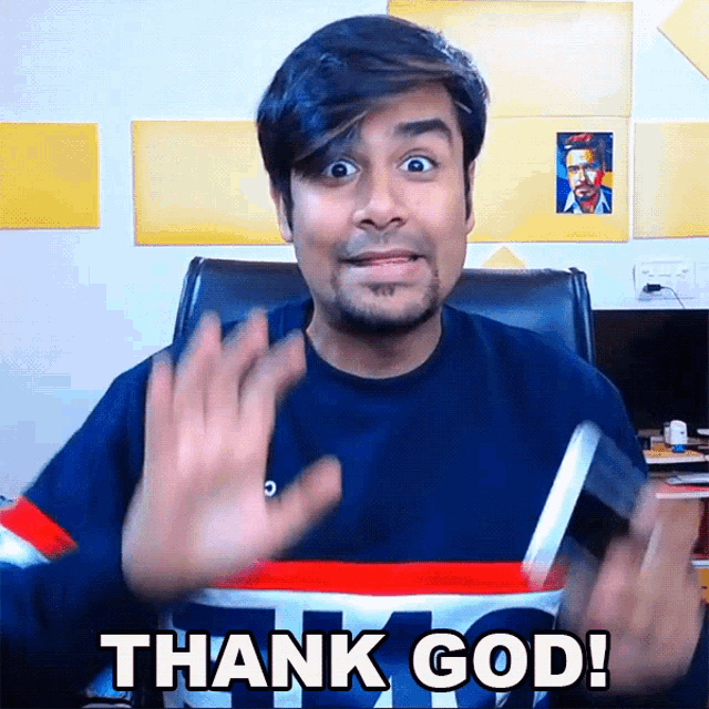 a man in a blue shirt says thank god with his hands