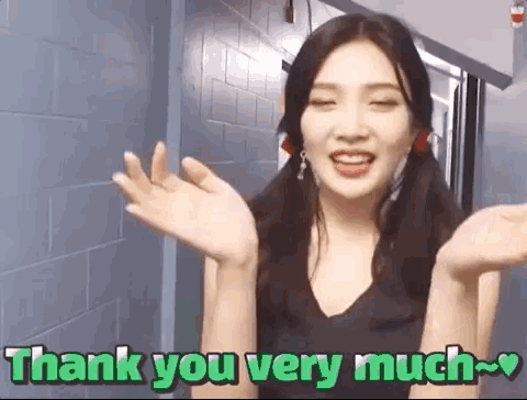 a woman is saying thank you very much with her hands outstretched
