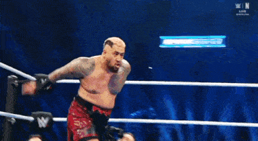 two men are wrestling in a ring with the letters n on the bottom