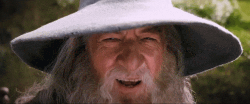 a man with a beard and a hat is making a funny face