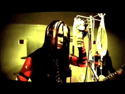 a man with dreadlocks is getting an injection from a syringe