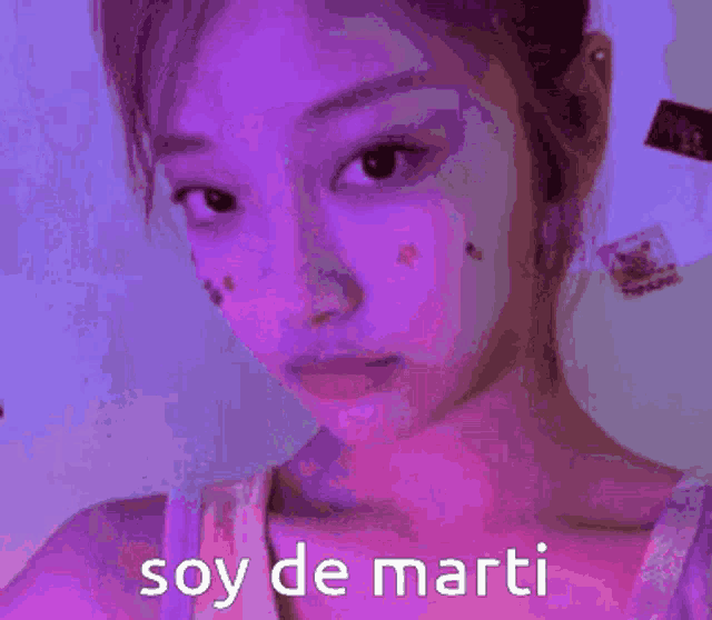 a close up of a woman 's face with the words soy de marti written on the bottom