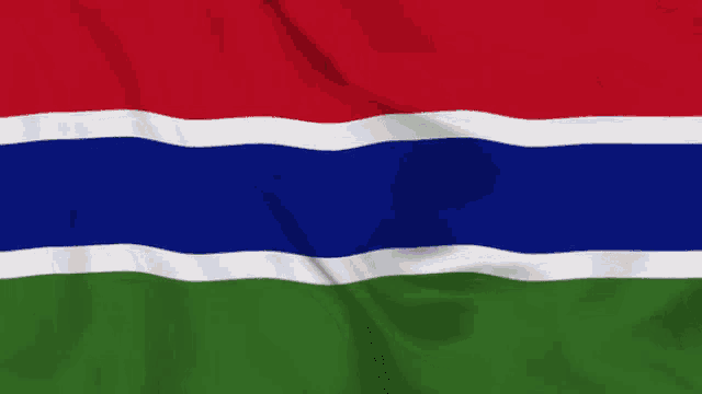 a flag with red blue and green stripes is waving in the wind