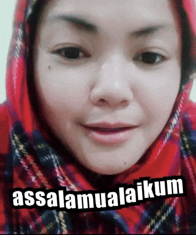 a woman wearing a red hijab is smiling with the words assalamualaikum behind her