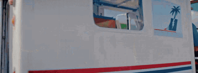 a man is sitting in the back of a mail truck with a palm tree on the side