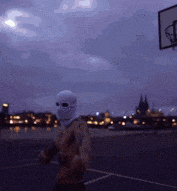 a man wearing a ski mask is standing in front of a basketball hoop