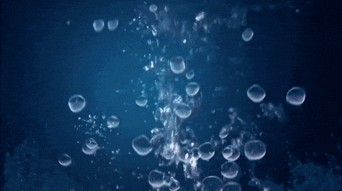a pink jellyfish is floating in the water with bubbles
