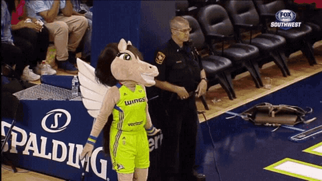a fox sports southwest broadcast of a basketball game with a mascot on the court