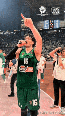 a basketball player in a green jersey with the number 16 on it