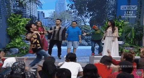 a group of people are standing in front of a crowd .