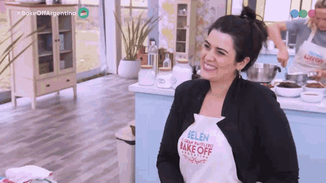 a woman is wearing an apron that says bake off on it