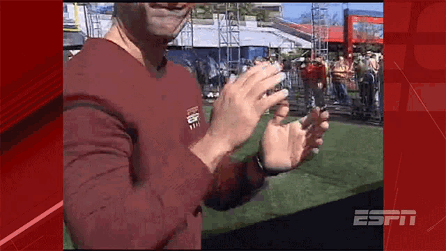 a man wearing a maroon shirt with espn on it