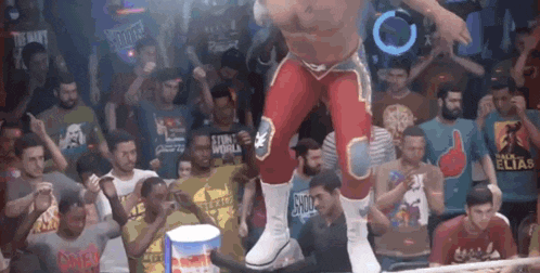 a wrestler in a red and white outfit is standing in front of a crowd .