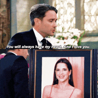 a man in a suit and tie holds a framed picture of a woman and says " you will always have my heart "