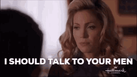 a woman is talking to a man and the words `` i should talk to your men '' are coming out of her mouth .