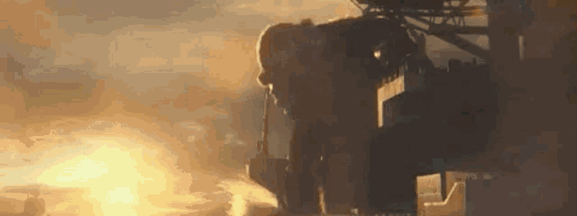 a man is standing on top of a building with a gun .