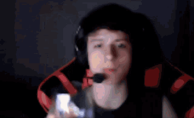 a blurry picture of a person wearing headphones and a headset