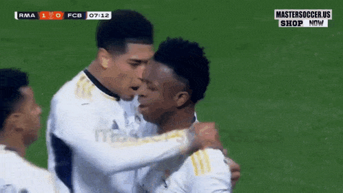 a group of soccer players are hugging each other on a field