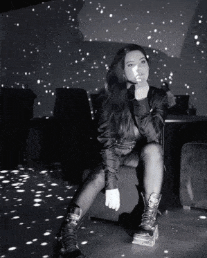 a black and white photo of a woman wearing a pair of boots with the word prada on them