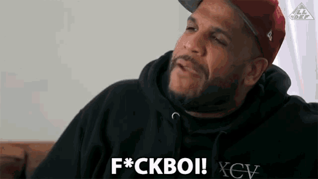 a man wearing a black hoodie says f * ckboi xev