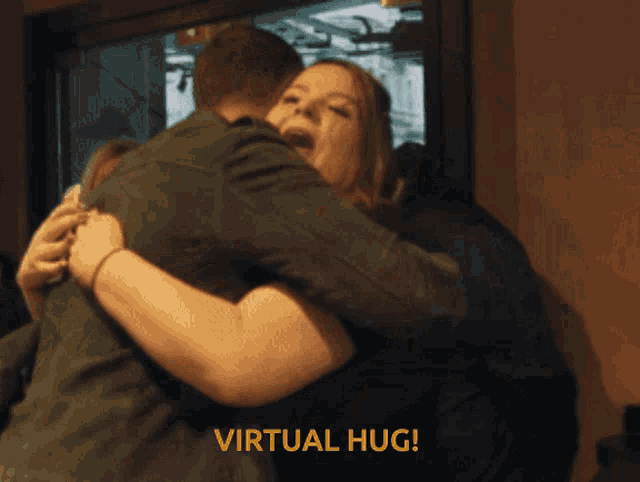 a man is hugging a woman with the words virtual hug written on the bottom
