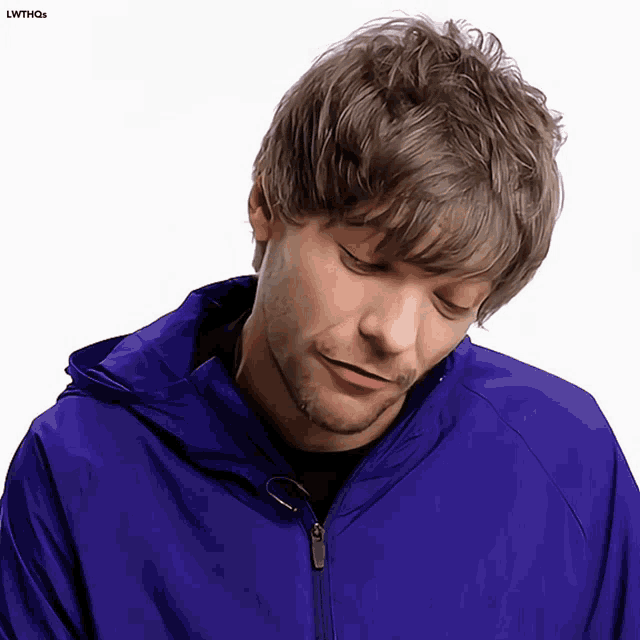 a man in a blue jacket is looking down with the words lwthqs below him
