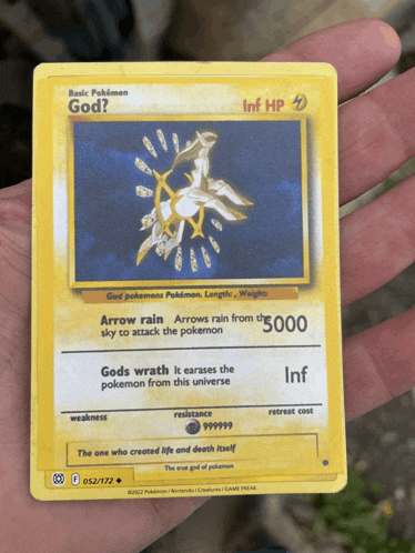 a person is holding a basic pokemon card that says god