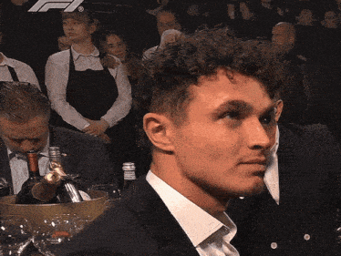 a man in a suit is looking at something in the distance
