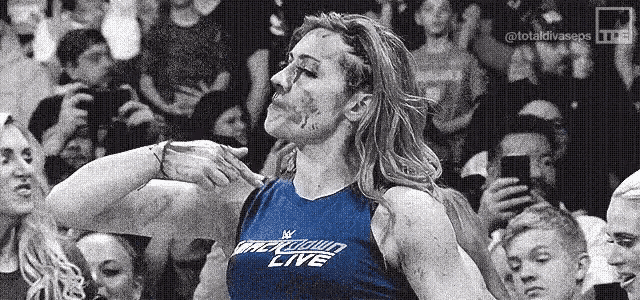 a black and white photo of a woman wearing a blue shirt that says ' mackdown live ' on it