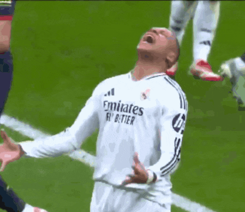 a soccer player wearing an emirates fly better shirt