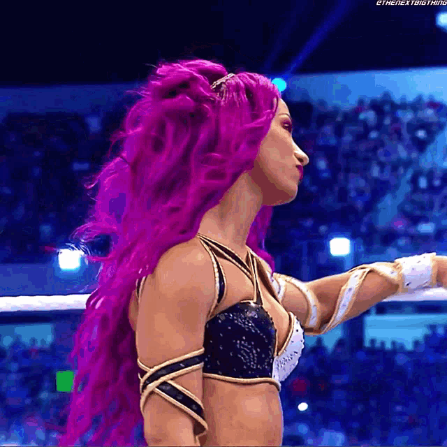 a woman with purple hair is wearing a black and white top