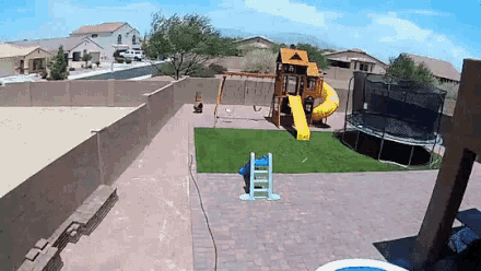 an aerial view of a backyard with a trampoline and a playground