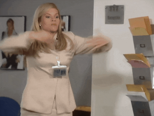a woman in a tan suit has a name tag that says " elizabeth " on it