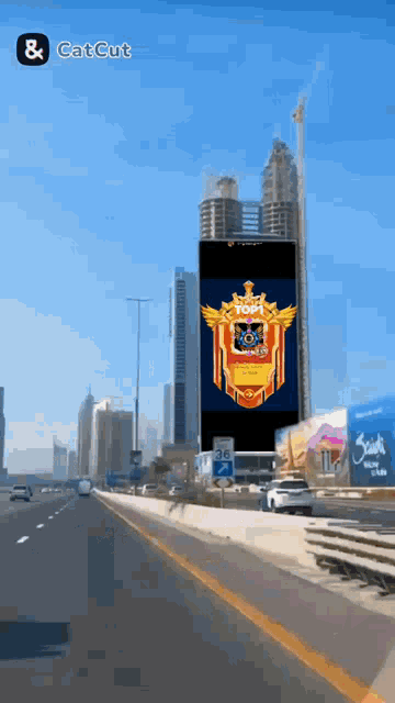 a large screen on a highway says top