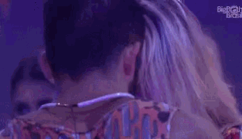 a man and a woman are standing next to each other and hugging .