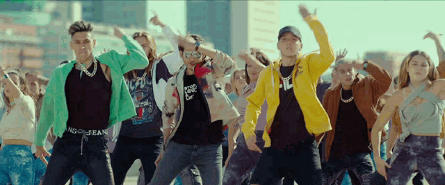 a group of people are dancing and one of them is wearing a t-shirt that says ac dc