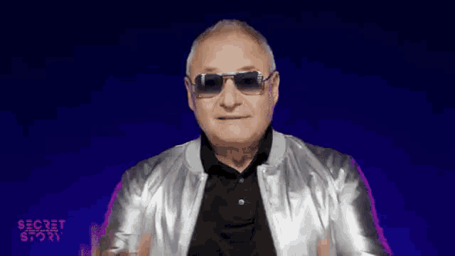 a man wearing sunglasses and a silver jacket is dancing in front of a blue background that says secret story
