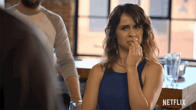 a netflix ad shows a woman covering her nose with her finger