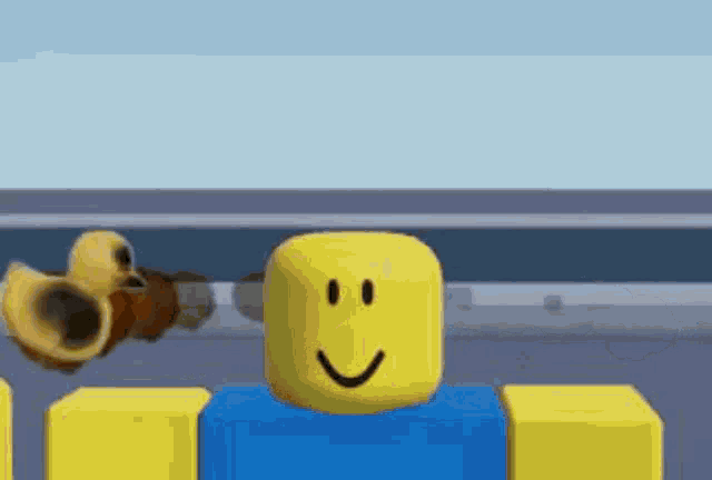 a yellow roblox character with a smile on his face is standing next to a blue block and a yellow block .