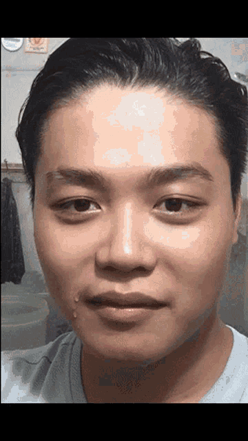 a close up of a man 's face with a tear coming out of his mouth