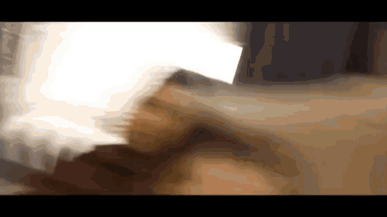 a blurred image of a person 's face with a light shining on it