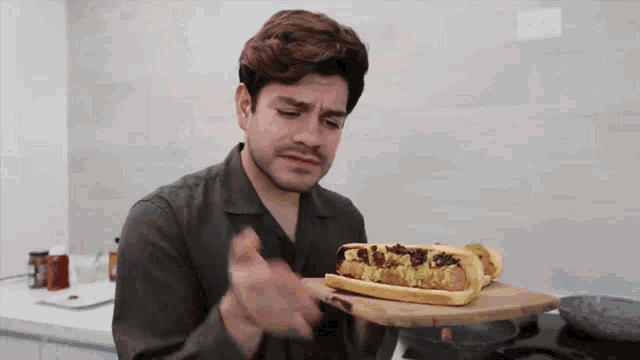 a man is eating a hot dog on a bun
