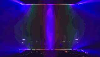 purple lights are shining on a dark room