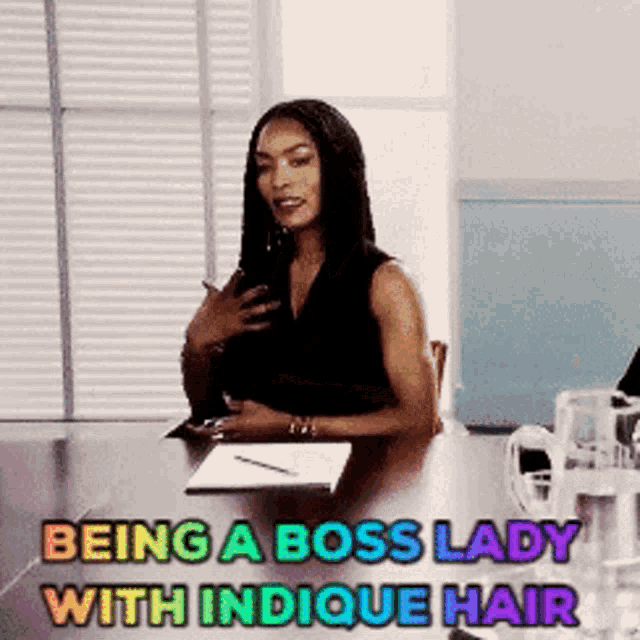 a woman sitting at a table with the words " being a boss lady with indicque hair "