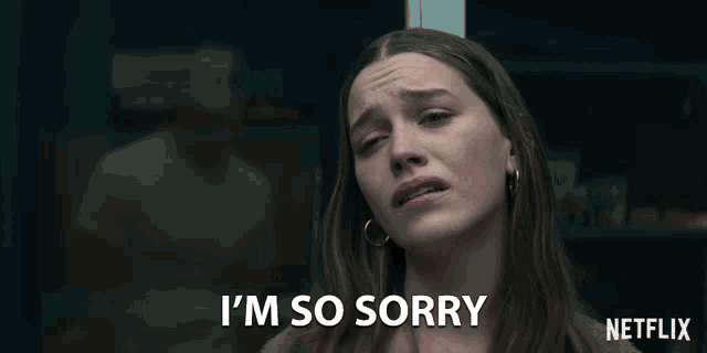 a woman says i 'm so sorry in front of a netflix sign