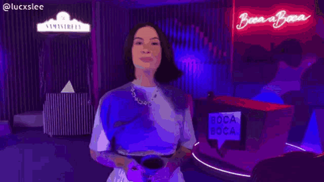 a woman is making a funny face in front of a sign that says ' luckslee '