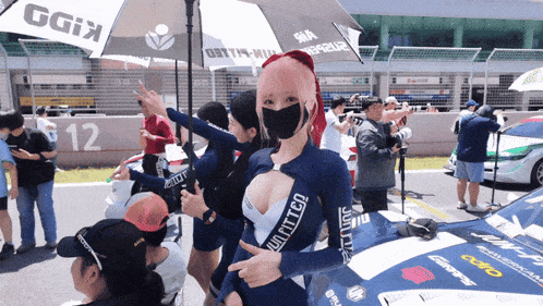 a woman wearing a mask holds an umbrella that says ggix on it