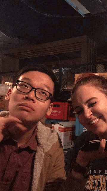 a man and a woman are sticking their tongues out in front of a box that says obms