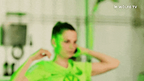 a woman in a green and white shirt with a vw logo on it