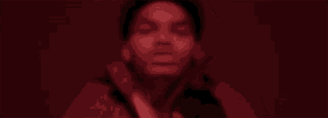 a close up of a person 's hands in a dark room